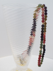 Tourmaline and gold bead necklace in hand blown champagne glass 